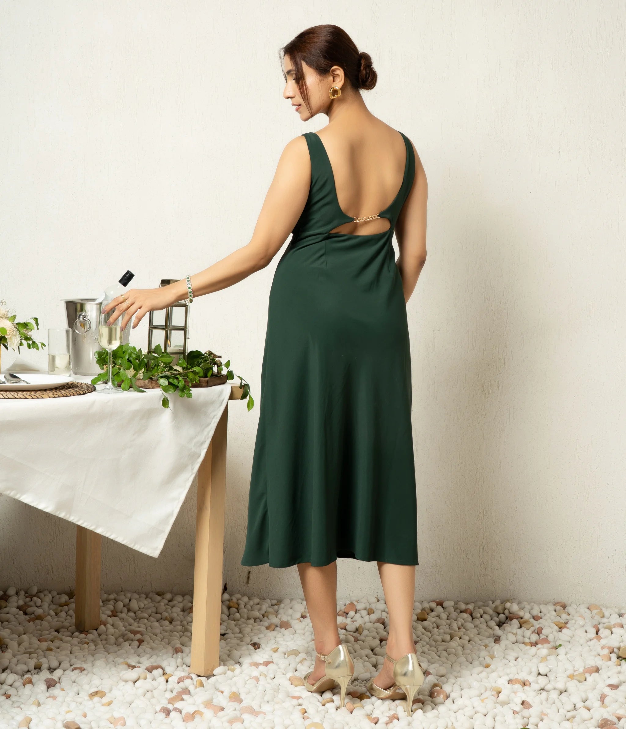 Forest green buckle dress with padded cups for party wear.
