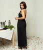 Elegant black gown with waistcoat belt and front slit.
